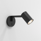 The matte black Ascoli Swing Reading Light from Astro Lighting in a studio.