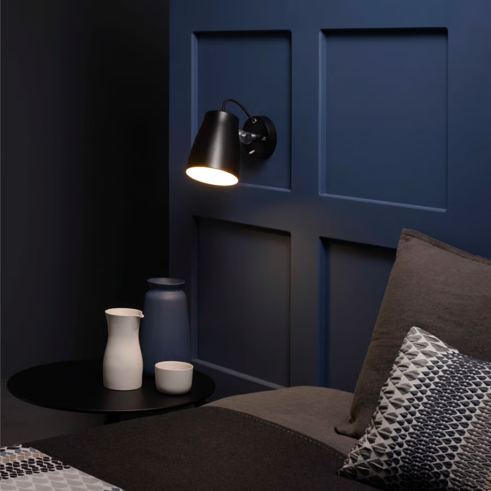 The Atelier Wall Sconce from Astro Lighting in a primary bedroom.