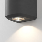 Close up of the light source of the Brixham Wall Single outdoor sconce in charcoal concrete by Astro Lighting.