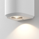 Close up of the light source of the Brixham Wall Single outdoor sconce in white concrete by Astro Lighting.
