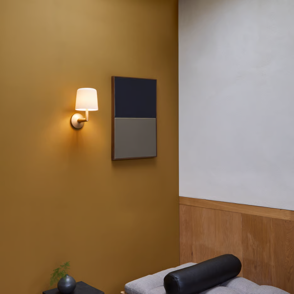 The light bronze Ella Wall Sconce from Astro lighting in a business meeting room.