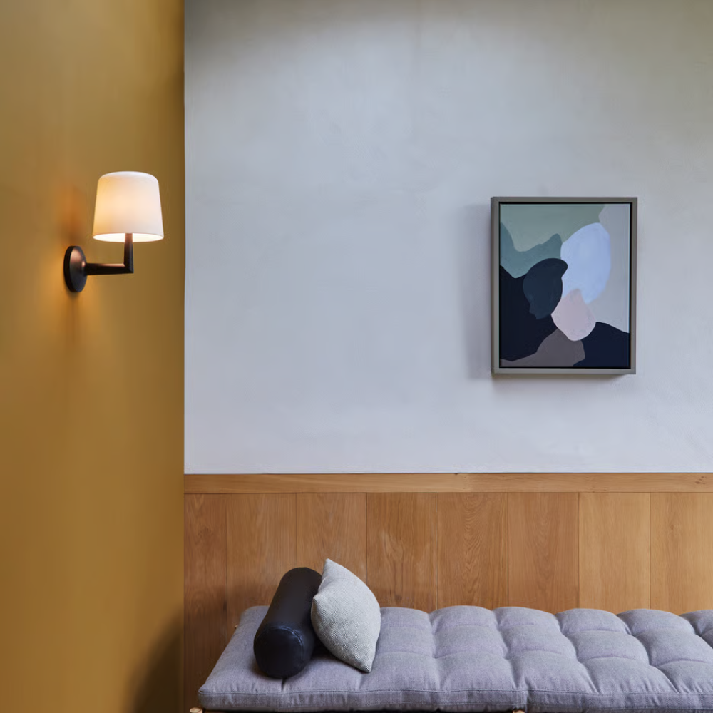 The matte black Ella Wall Sconce from Astro lighting in a family space.