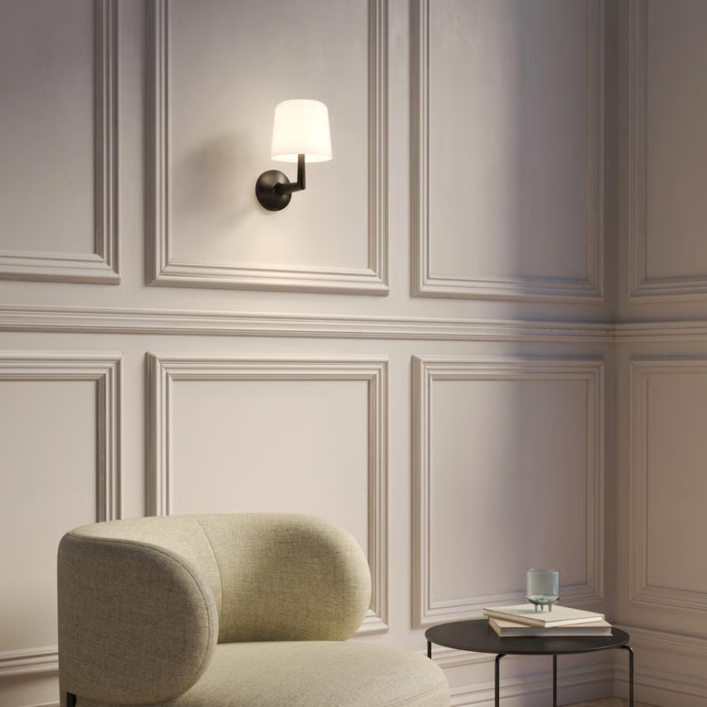 The matte black Ella Wall Sconce from Astro lighting in a living room.