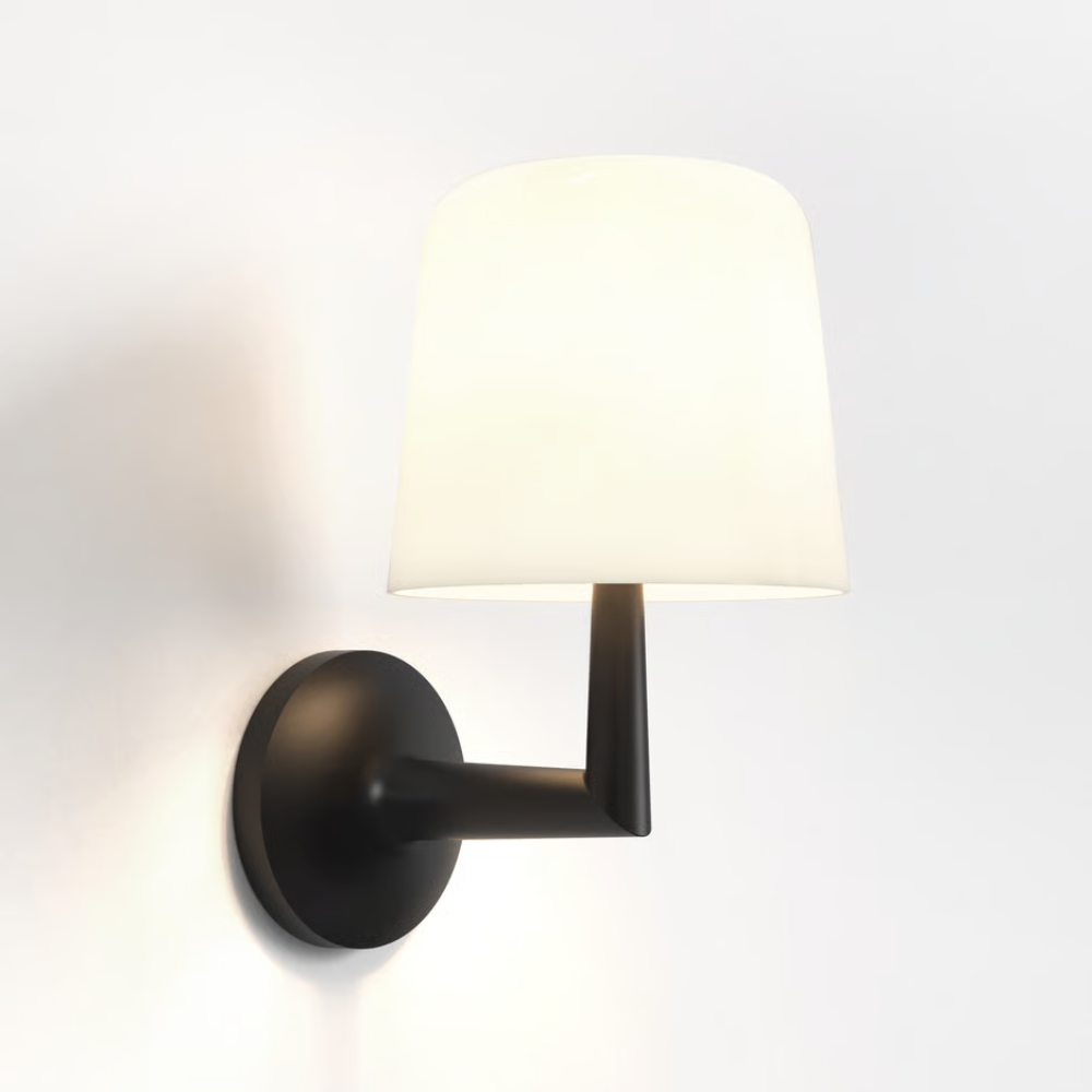 The matte black Ella Wall Sconce from Astro lighting in a studio.