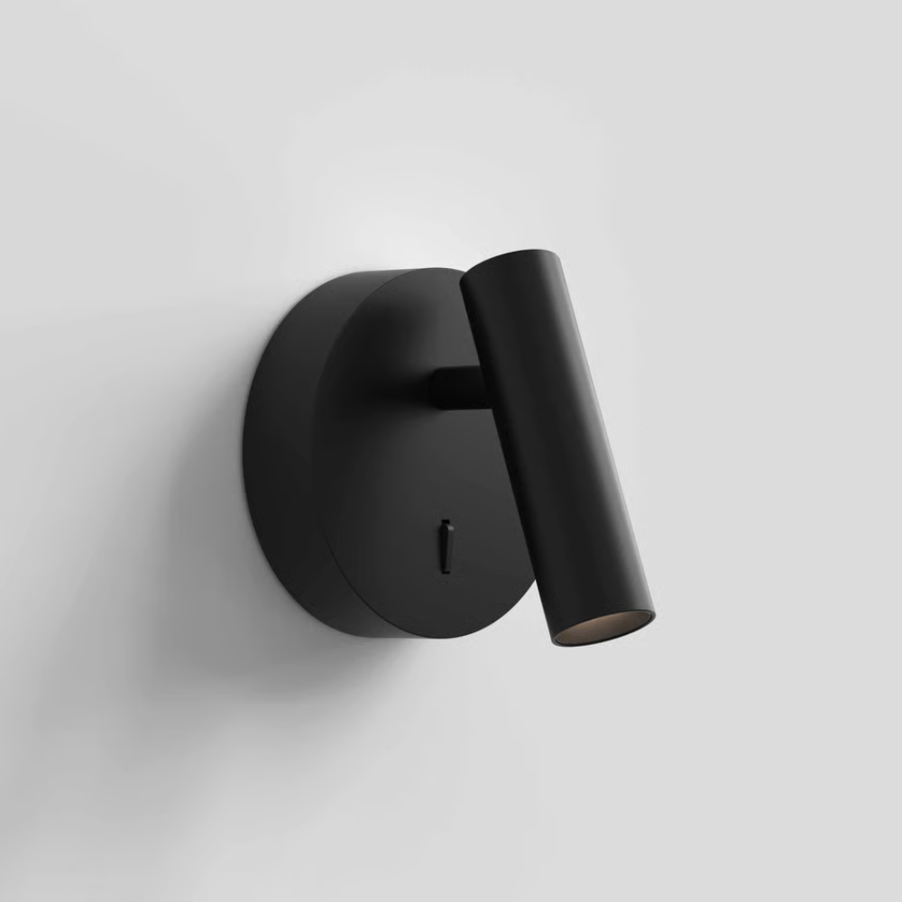The matte black Enna Surface Round Wall Sconce from Astro Lighting in a family area.
