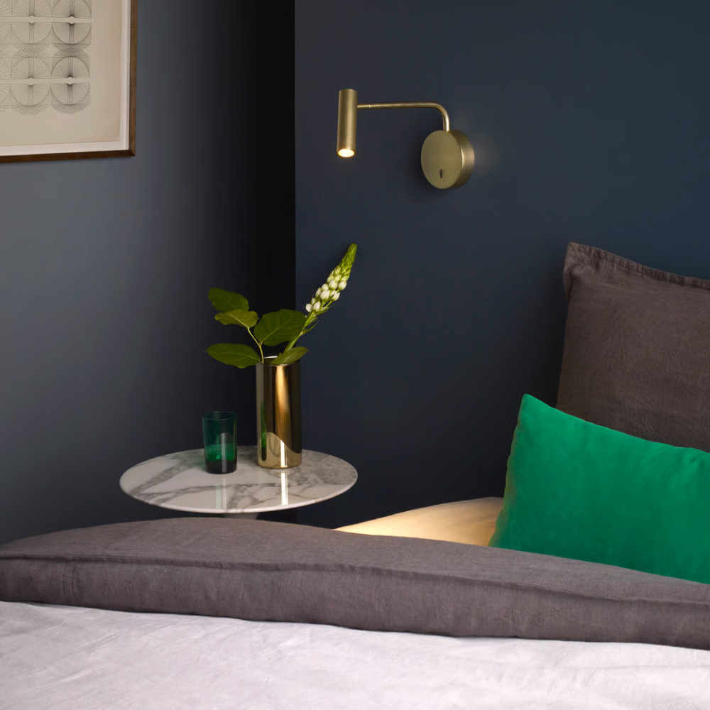 The matte gold Enna Wall LED from Astro Lighting in a primary bedroom.