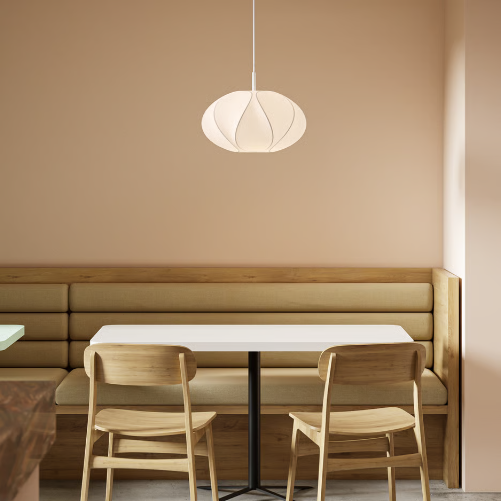 The small Flow Pendant from Astro Lighting with the matte white base in a dining room.