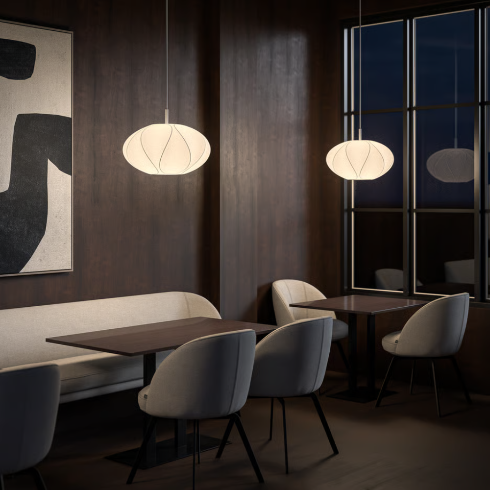 The small Flow Pendant from Astro Lighting with the matte white base in a living room.