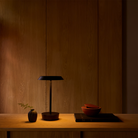 The Halo Portable Lamp from Astro Lighting in matt black in a guest bedroom.