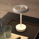 The Halo Portable Lamp from Astro Lighting in matt white on a coffee table.