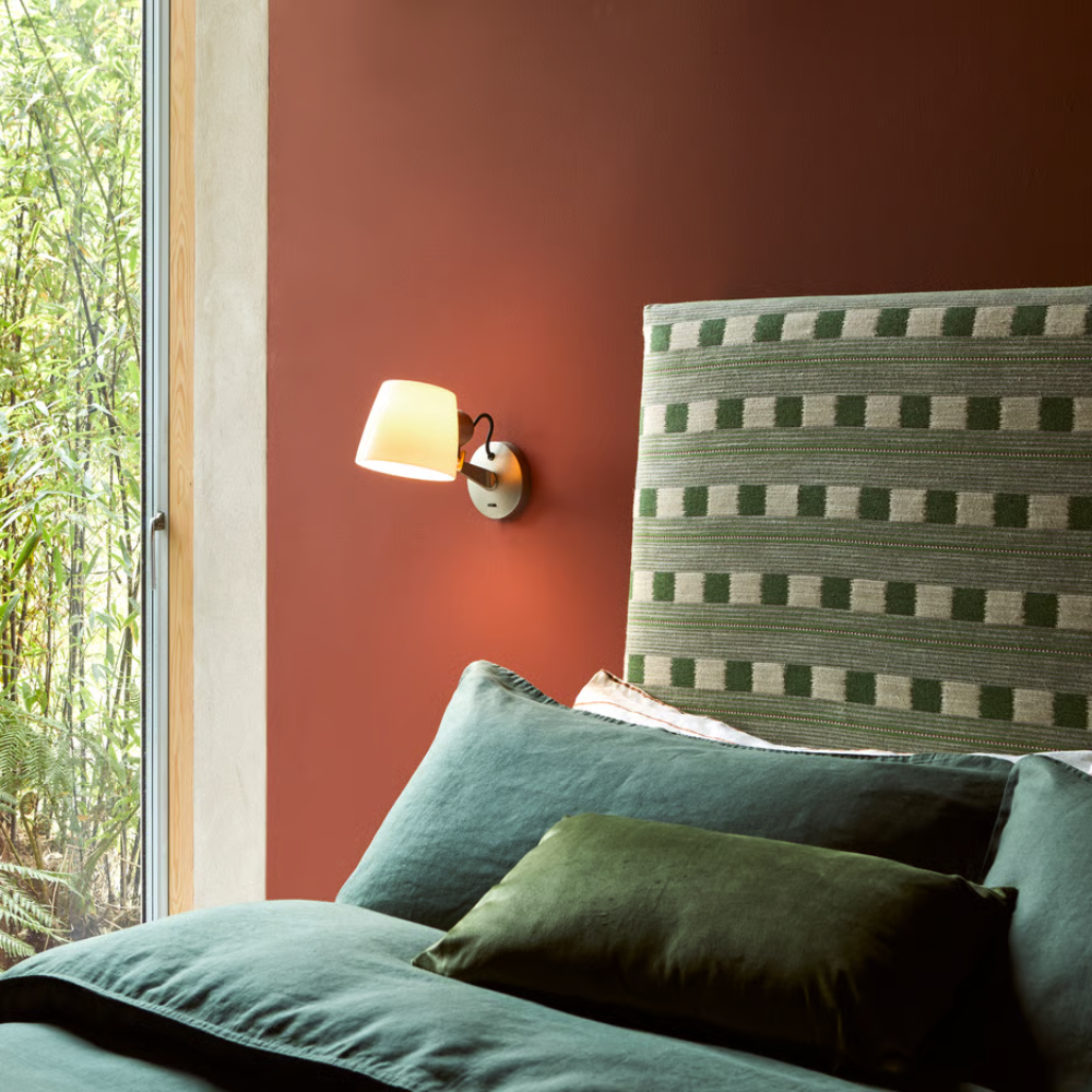 The matte nickel Imari Adjustable Wall Sconce from Astro Lighting in a guest bedroom.