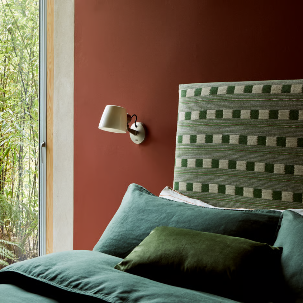 The matte nickel Imari Adjustable Wall Sconce from Astro Lighting in a hotel room.