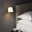 The Imari Wall Lamp from Astro Lighting in bronze in a primary bedroom.