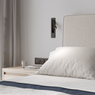 The matte black Keta Reading Light from Astro Lighting in a primary bedroom.
