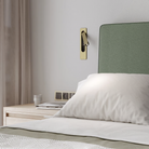The matte gold Keta Reading Light from Astro Lighting in a guest bedroom.
