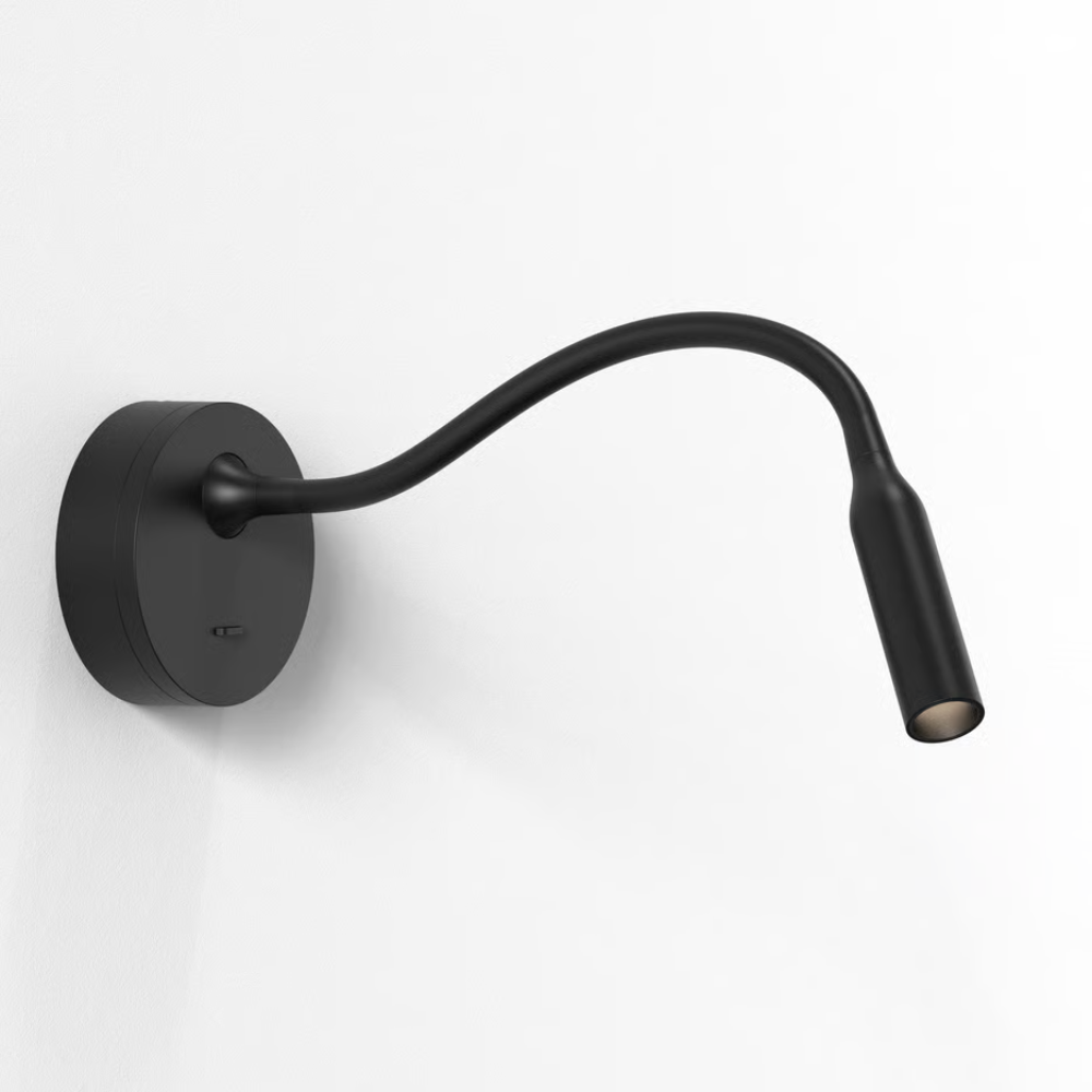 The matte black Lucca Surface Wall Sconce from Astro Lighting in a living room.