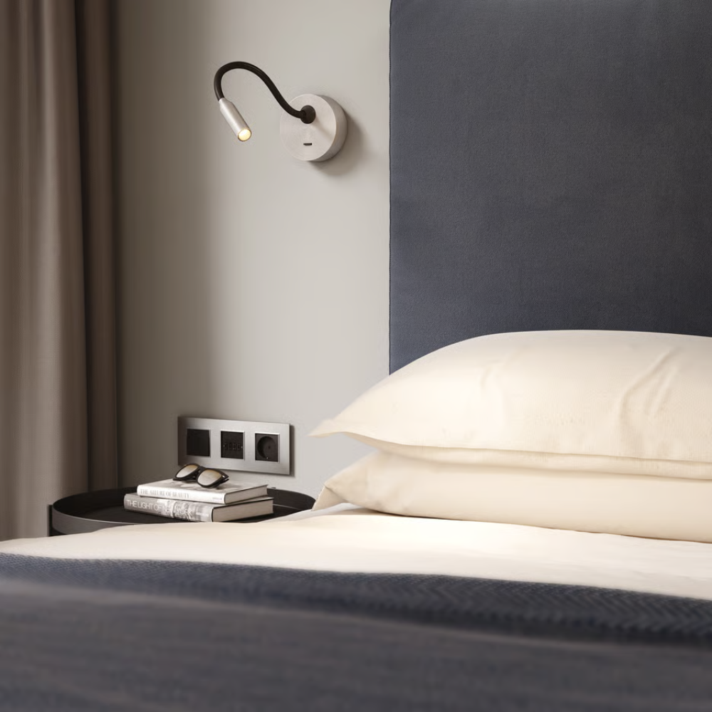 The matte nickel Lucca Surface Wall Sconce from Astro Lighting used as directional bedside lighting.