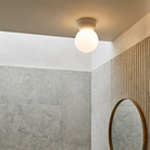 The Large Lyra Ceiling Flush Mount from Astro Lighting in a bathroom