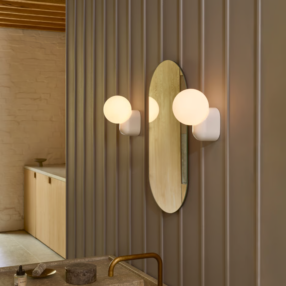 The Lyra Wall Sconce from Astro Lighting in a living room above a wet bar.