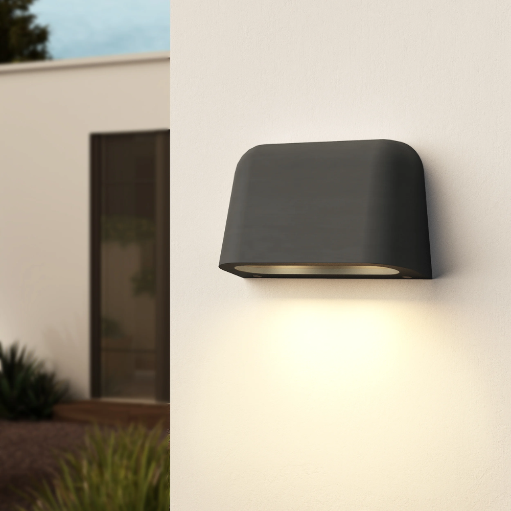 The Mast Twin Coastal Outdoor Wall Sconce by Astro Lighting in charcoal concrete installed outside during the day.