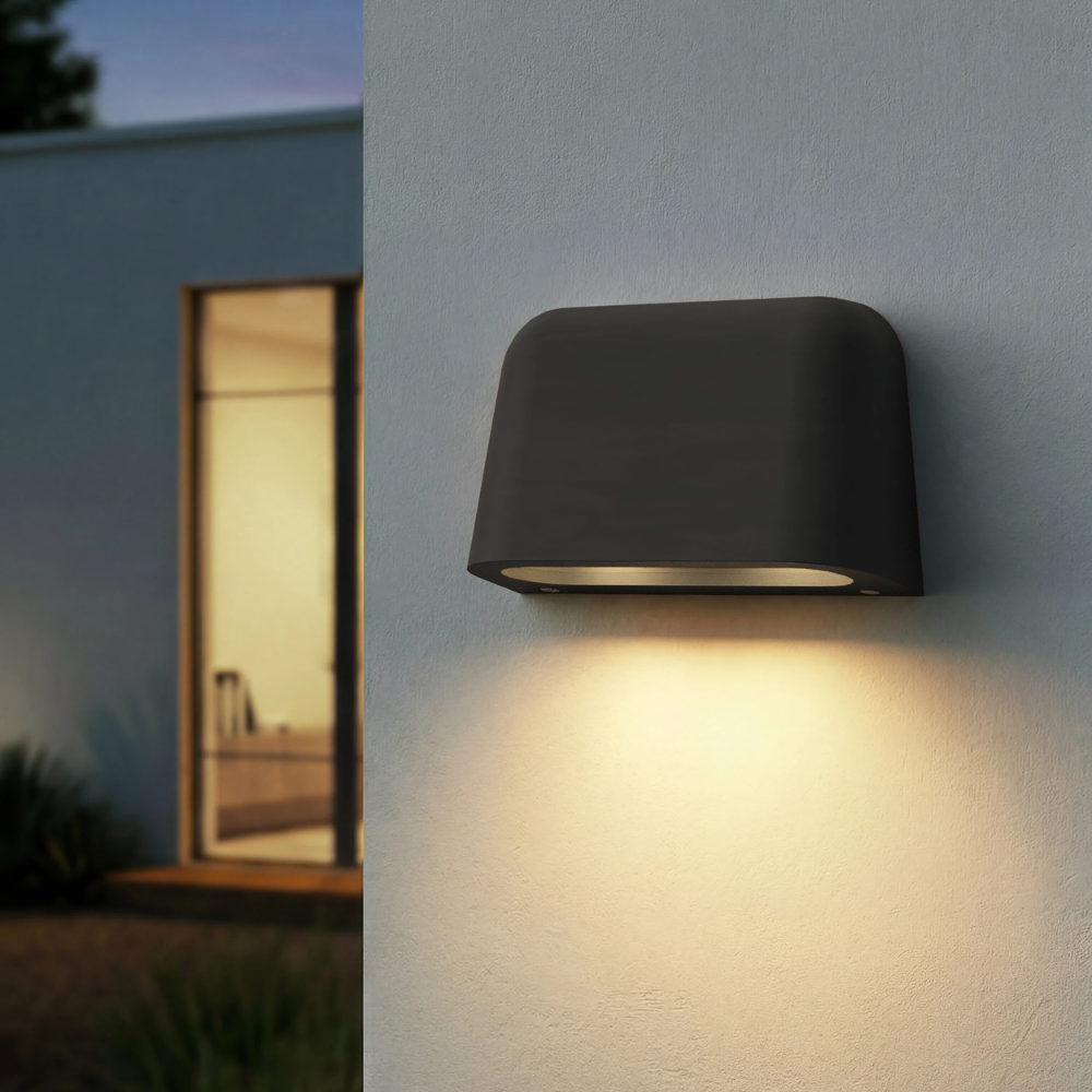 The Mast Twin Coastal Outdoor Wall Sconce by Astro Lighting in charcoal concrete installed outside at night.
