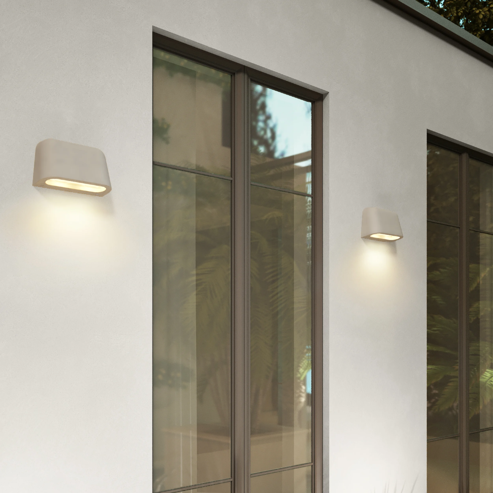 The Mast Twin Coastal Outdoor Wall Sconce by Astro Lighting in grey concrete installed on the exterior of a home.
