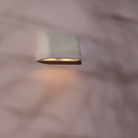 The Mast Twin Coastal Outdoor Wall Sconce by Astro Lighting in grey concrete installed on a mauve concrete wall.