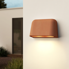 The Mast Twin Coastal Outdoor Wall Sconce by Astro Lighting in terracotta concrete installed outside during the day.