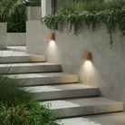 The Mast Twin Coastal Outdoor Wall Sconce by Astro Lighting in terracotta concrete installed on a stairway during the day.