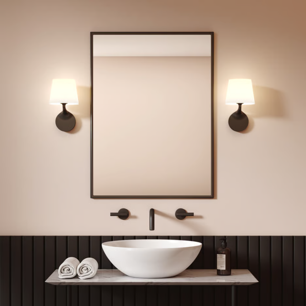 The black Millie Wall Sconce from Astro Lighting in a primary bathroom.