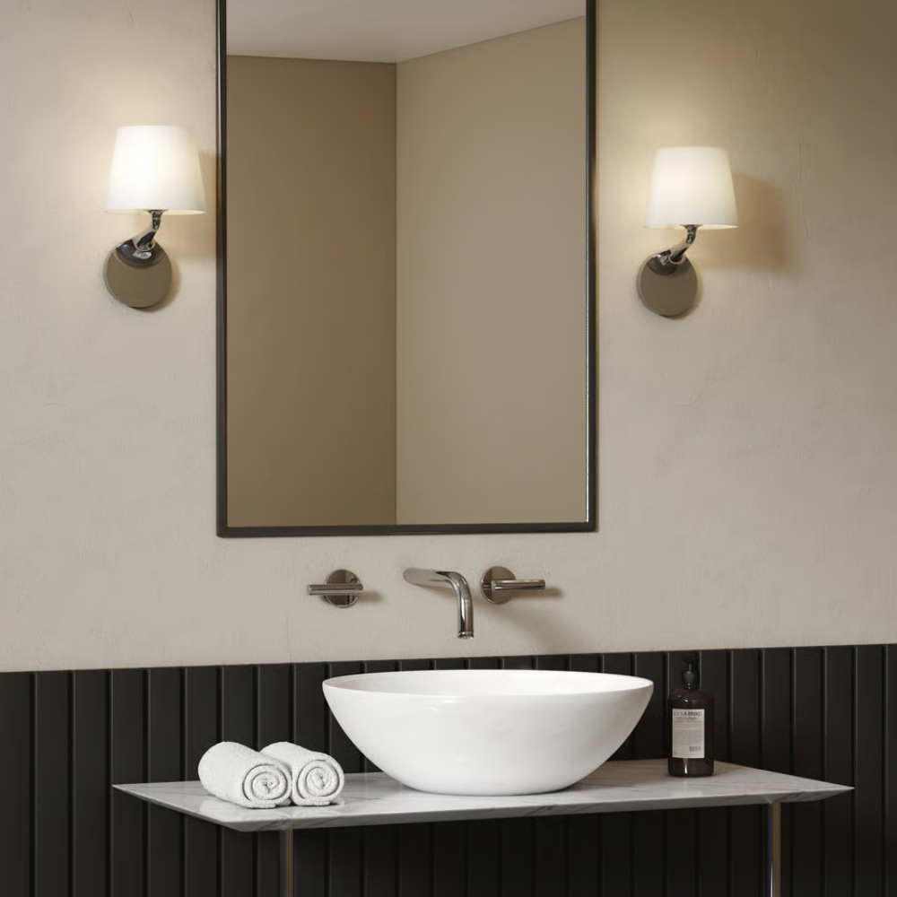 The polished chrome Millie Wall Sconce from Astro Lighting in a guest bathroom.
