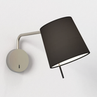 The matte nickel Mitsu Swing Arm Wall Sconce from Astro Lighting with the black shade in a hospitality space.