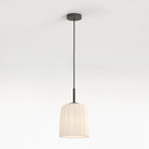 The medium Veo Pendant from Astro Lighting in a studio.
