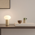 The Zeppo Portable Lamp from Astro Lighting in light bronze in an entryway.