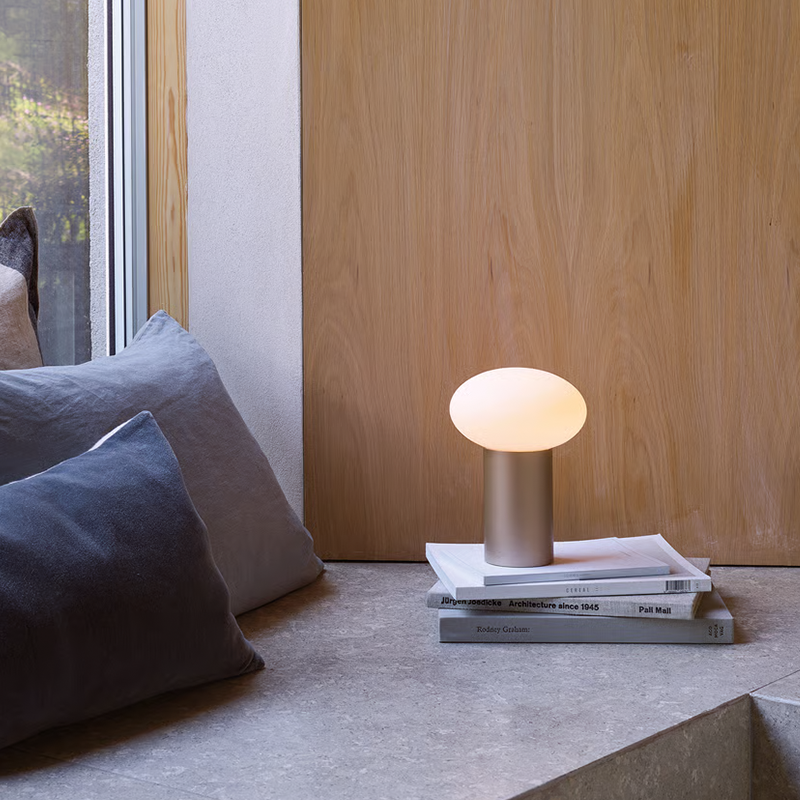 The Zeppo Portable Lamp from Astro Lighting in light bronze in a lounge.