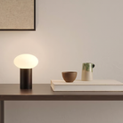 The Zeppo Portable Lamp from Astro Lighting in matt black in a hallway.