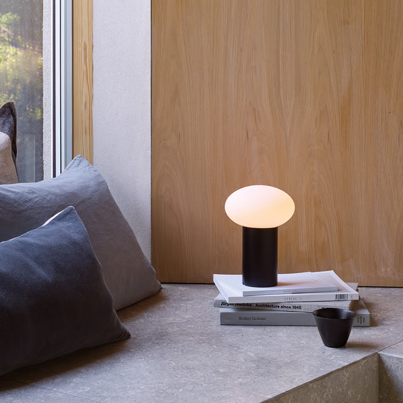 The Zeppo Portable Lamp from Astro Lighting in matt black in a living room.