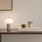 The Zeppo Portable Lamp from Astro Lighting in pebble grey in an entryway.