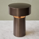 The Column Portable Table Lamp from Audo Copenhagen in anodized aluminum in a lounge.