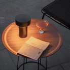 The Column Portable Table Lamp from Audo Copenhagen in anodized aluminum in a restaurant.