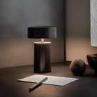 The Column Portable Table Lamp from Audo Copenhagen in anodized aluminum in a study room.