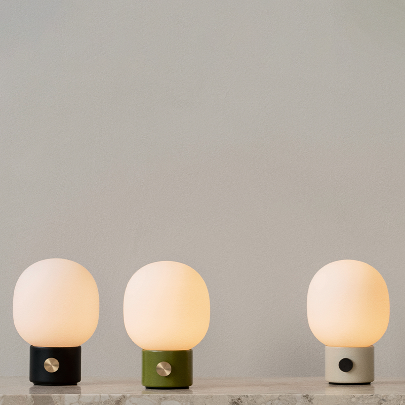 The JWDA Portable Table Lamp from Audo Copenhagen in a living room. all-groups