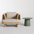 The sunbrella stucco Loophole Outdoor Lounge Chair from Bludot with a circular outdoor side table in a modern outdoor setting. 