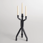 The Nosferatube Small Candelabra from Blu Dot in black in a living room studio.