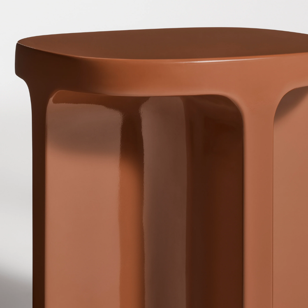 The rust Small Talk Side Table from Bludot with edge close up.
