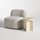 The ivory Small Talk Tall Side Table from bludot with looksee swivel lounge chair in studio.