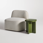 The olive Small Talk Tall Side Table from bludot with looksee swivel lounge chair in studio.