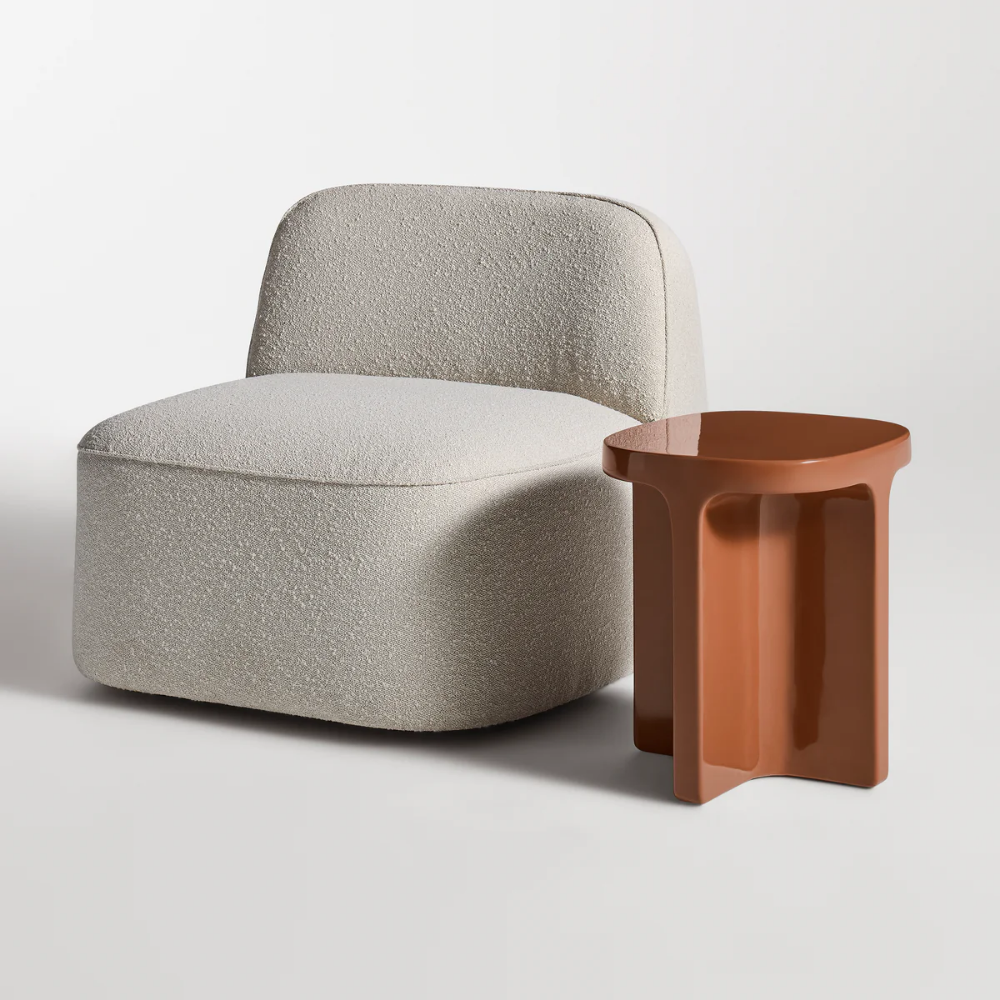 The rust Small Talk Tall Side Table from bludot with looksee swivel lounge chair in studio.