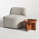 The rust Small Talk Short Side Table from Bludot with looksee swivel lounge chair in studio.