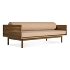 The Souvenir Sofa from Blu Dot with the irving copper stripe upholstery and walnut frame from an angle.